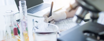 Hand writing medical results down in forensics lab