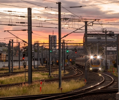 Train entering Roma Street Station Brisbane at sunset